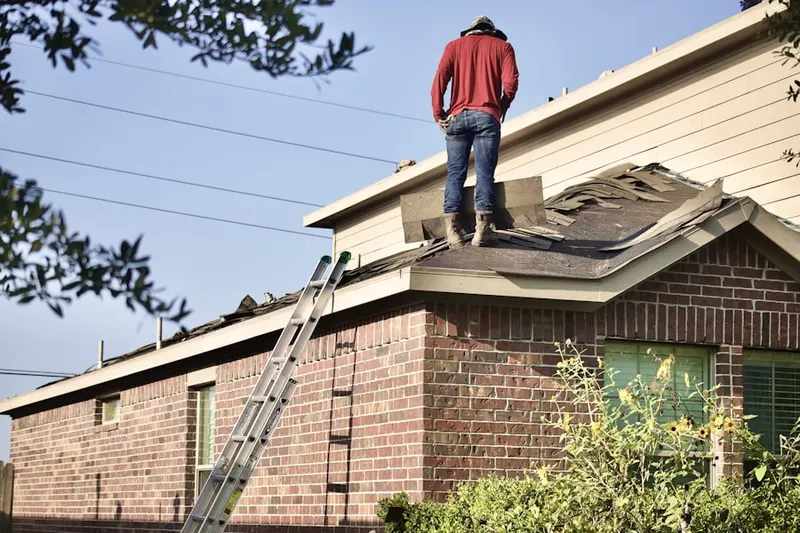 Professional roofer working on a residential roof in Putnam